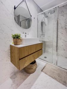 a bathroom with a sink and a shower at Cozy Luxury Apartment in Aveiro in Aveiro +5 photos