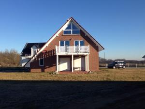 a brick house with a porch on a field at Haus Seeblick in Alt Schwerin