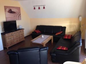 a living room with a couch and a table at Haus Seeblick in Alt Schwerin
