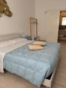 a large bed with two pillows on top of it at Avia Room in Pachino +32 photos