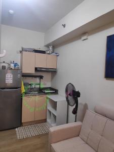a living room with a couch and a kitchen at Paseo Verde Daily Staycation in Manila