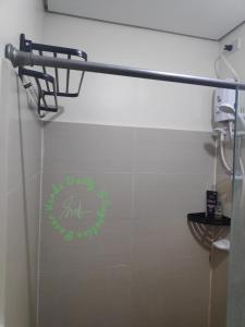a bathroom with a sign on the wall of a toilet at Paseo Verde Daily Staycation in Manila