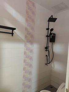 a bathroom with a shower and a toilet in it at Rest Stay Hatyai in Ban Khlong Toei (1)