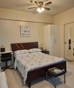 a bedroom with a bed and a ceiling fan at Condo Airport NAIA Terminal-3 One Palm Tree Villas in Manila