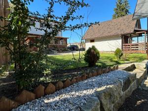 a stone retaining wall in front of a house at Domek przy Rozpadlisku in Podgórzyn