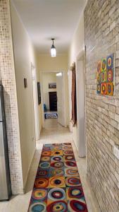 a hallway with a colorful rug on the floor at The play house in Cairo