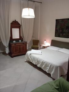 a bedroom with a bed and a dresser and a mirror at Casa San Carlo Affittacamere Foligno in Foligno +30 photos