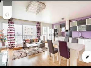 a kitchen and living room with a table and chairs at Chambre proche aéroport Orly à 3 min du T12 in Viry-Châtillon