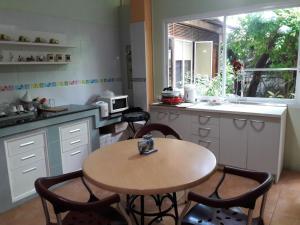 a kitchen with a table and chairs and a sink at Baan Malee in Phuket Town