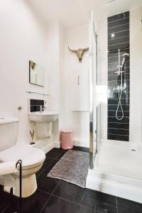 a bathroom with a shower and a toilet and a sink at Luxury Seaview Gated Penthouse located near Edinburgh in Kirkcaldy +21 photos