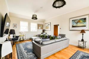 a living room with a couch and a table at Luxury Seaview Gated Penthouse located near Edinburgh in Kirkcaldy