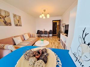 a living room with a couch and a table at Hellen Studio Predeal in Predeal