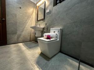 a bathroom with a toilet and a sink at Curve Hiri in Dickwella