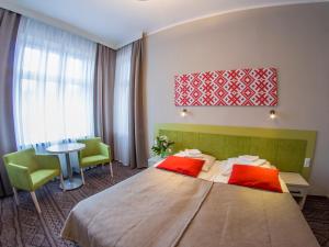 Łóżko lub łóżka w pokoju w obiekcie Hotel *** NAT Krynica Zdrój