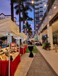 a market with a table of food on a street at Condo Airport NAIA Terminal-3 One Palm Tree Villas in Manila