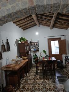 a kitchen with a table and a dining room at b&b s'antalena in Orgosolo