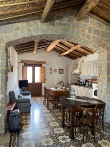 a kitchen and living room with a table and chairs at b&b s'antalena in Orgosolo