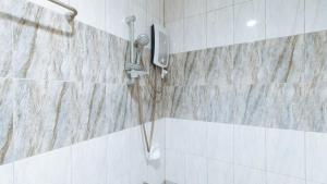 a shower with a shower head in a bathroom at WestCourt Inn Ilocos Sur in Bantaoay +18 photos