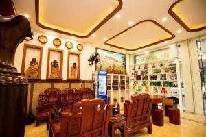 a store with wooden chairs and clocks on the wall at SUNSHINE HOTEL in Quy Nhon +17 photos