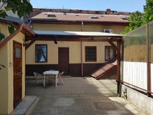 a patio of a house with a table and a slide at Central Victoriei Guesthouse in Bucharest