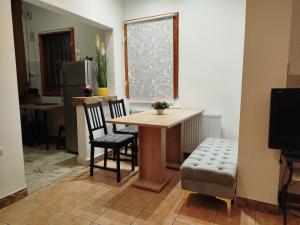a dining room with a table and chairs and a window at Central Victoriei Guesthouse in Bucharest