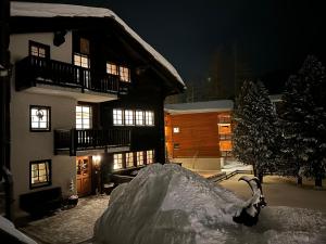 a pile of snow in front of a building at Lomatte 1758 in Saas-Fee