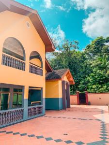 a house with a tile courtyard in front of it at Renda Residence Apartment in Takoradi