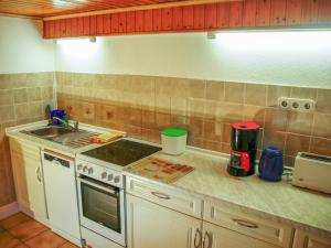 a kitchen counter with a stove and a sink at Ferienwohnung Joachim in Ribnitz-Damgarten