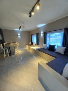 a living room with two beds and a table at Villa SunShine exclusive in Watamu