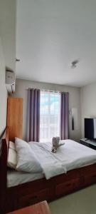 a bed with a stuffed animal sitting on top of it at Jack's Cabin in Suba +48 photos