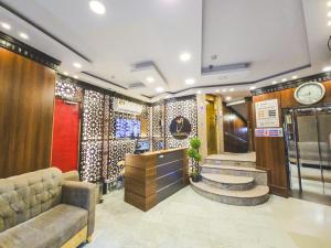 a lobby with a bar and a clock on the wall at Jawad Al-Taj Hotel in Mecca