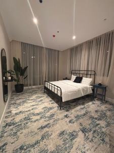 a bedroom with a bed and a large rug at Samo Apartment in Taif