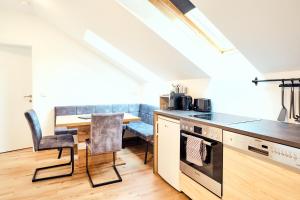 a kitchen with a table and a dining room at Ferienwohnung Muthenthaler, Wachau in Schwallenbach