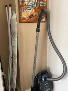 a vacuum cleaner is hanging on a wall at Modern and cozy apartment in good location in Berlin