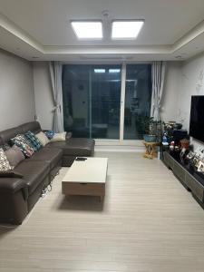a living room with a couch and a coffee table at Byeollae Station I-park Suite Apartment 16F in Namyangju