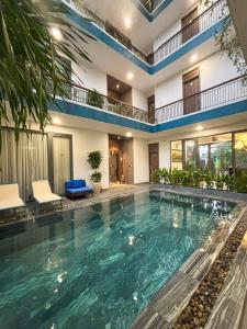 a large swimming pool in the middle of a building at The Nam An Villa Hoi An in Hoi An