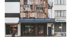 a building with a fire escape on top of it at Bedgasm Hostel Chanthaburi in Chanthaburi