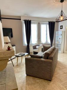 a living room with a couch and a table at Gites L etape conviviale in Guitté