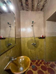 a bathroom with a gold sink and a shower at Heritage House Skoura in Skoura +70 photos