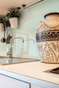 a vase sitting on a counter in a kitchen at VAQUAY Alkina In Hawthorn in Melbourne