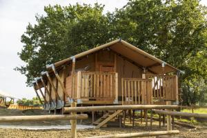 a small wooden cabin with a slide in a park at Glamping Tenuta Radici in Castelnuovo della Misericordia