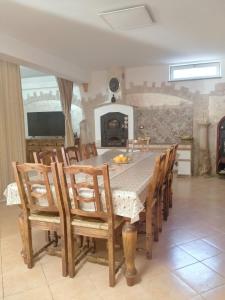 a dining room with a table and chairs and a fireplace at Casa Flasia in Capranica