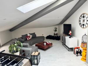 a living room with a couch and a tv at Attico the Queen2 in Caravaggio