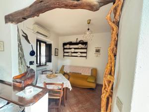 a living room with a table and a couch at Su Niu in Ulassai