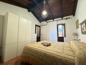 a bedroom with a large bed with a teddy bear on it at Su Niu in Ulassai