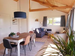 a living room with a table and chairs and a couch at 't Nieuwe Nest in Kaatsheuvel