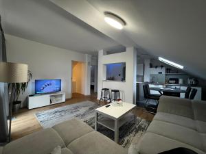 a living room with a couch and a table at House in Village apartman Jelić in Topolovac