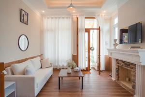 a living room with a white couch and a fireplace at 2bi s home DALAT 2 in Da Lat