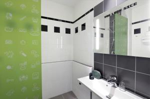 a bathroom with a sink and a mirror at Ibis Styles Budapest Center in Budapest