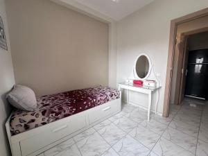 a bedroom with a bed and a dressing table and a mirror at Blue Horizon Apartment in Dar Bouazza +3 photos